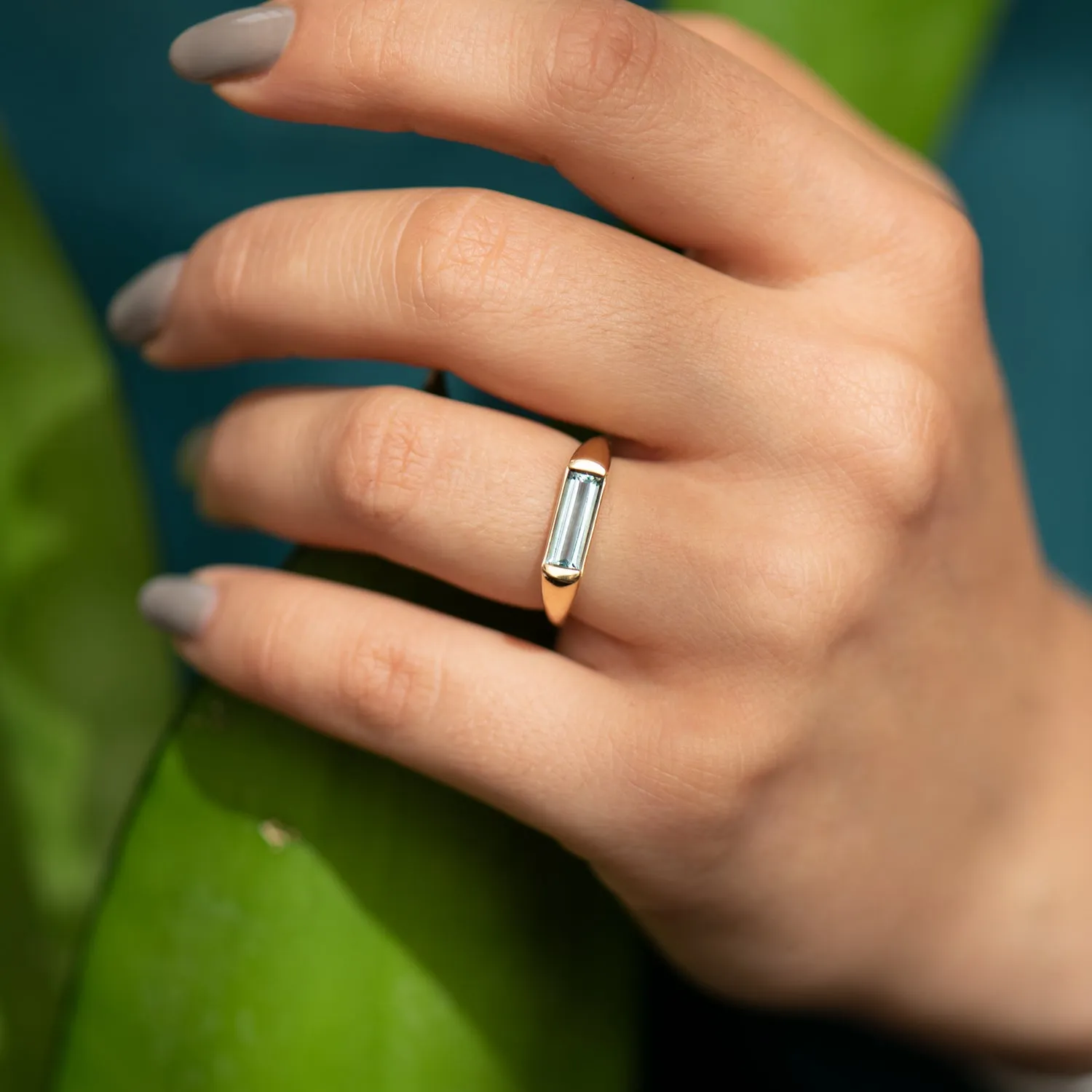 Modern Solitaire Ring with a Baguette Cut Aquamarine